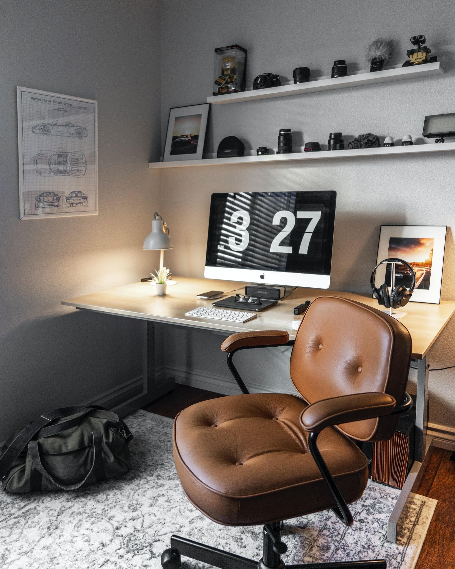 turned-on silver iMac, on wooden desk in home office